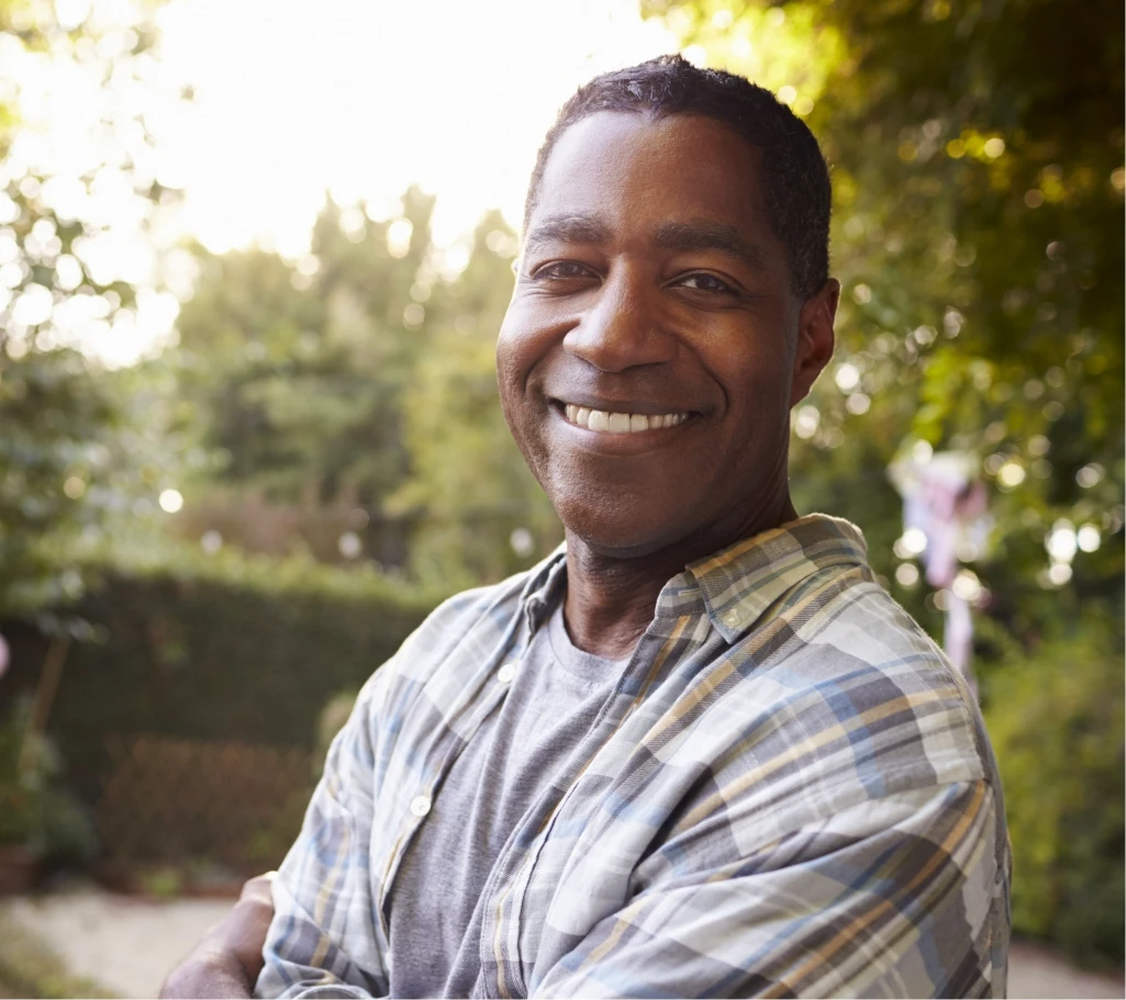 Smiling man wearing a plaid shirt